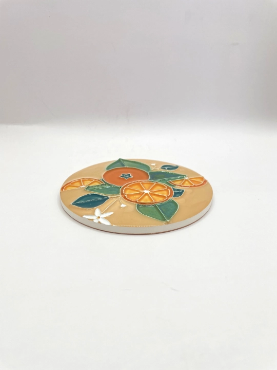 Ręcznie robiona podstawka ceramiczna z motywem pomarańczy